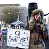 The Rise of QAnon and the Risk It Could Pose to America